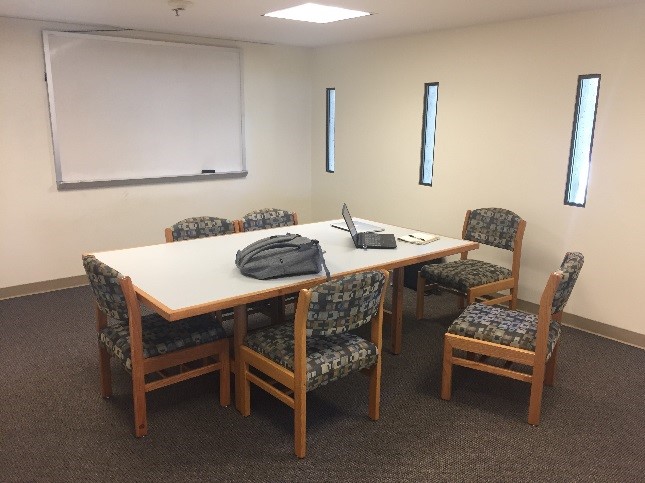 BLB Room 201: rectangular table, 6 chairs, one mounted whiteboard